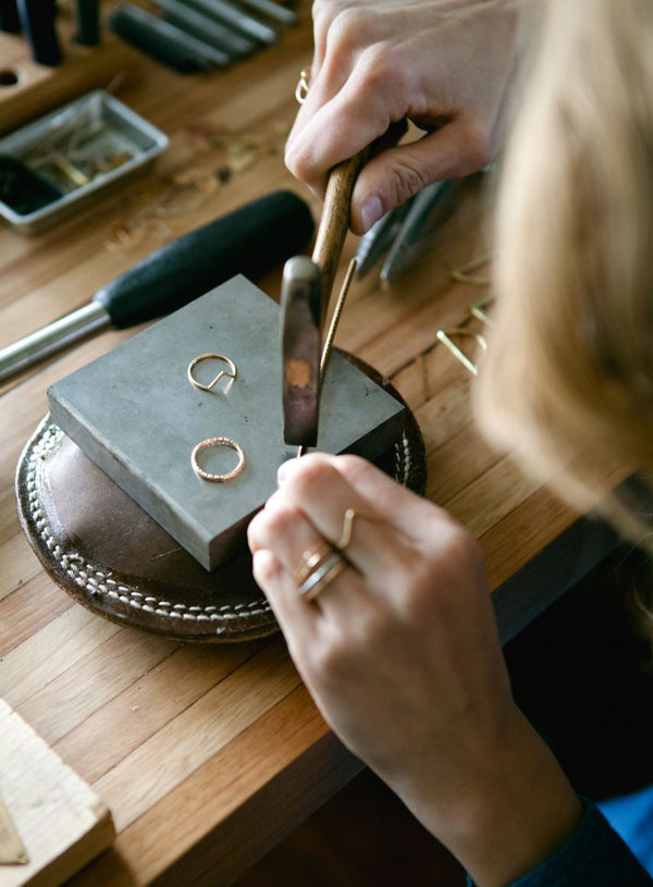 Jeweller carefully crafting a bespoke name necklace in our workshop