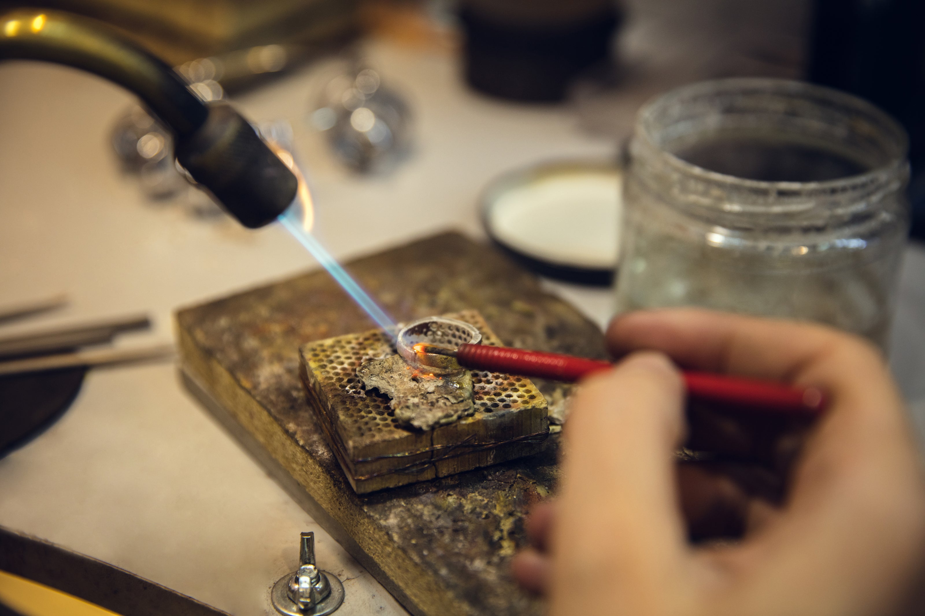 Close-up of hands creating a custom jewellery piece by hand